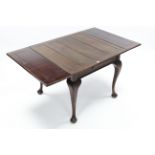 A 1930’s mahogany draw-leaf dining table on four slender cabriole legs & pad feet, 36” x 60” (