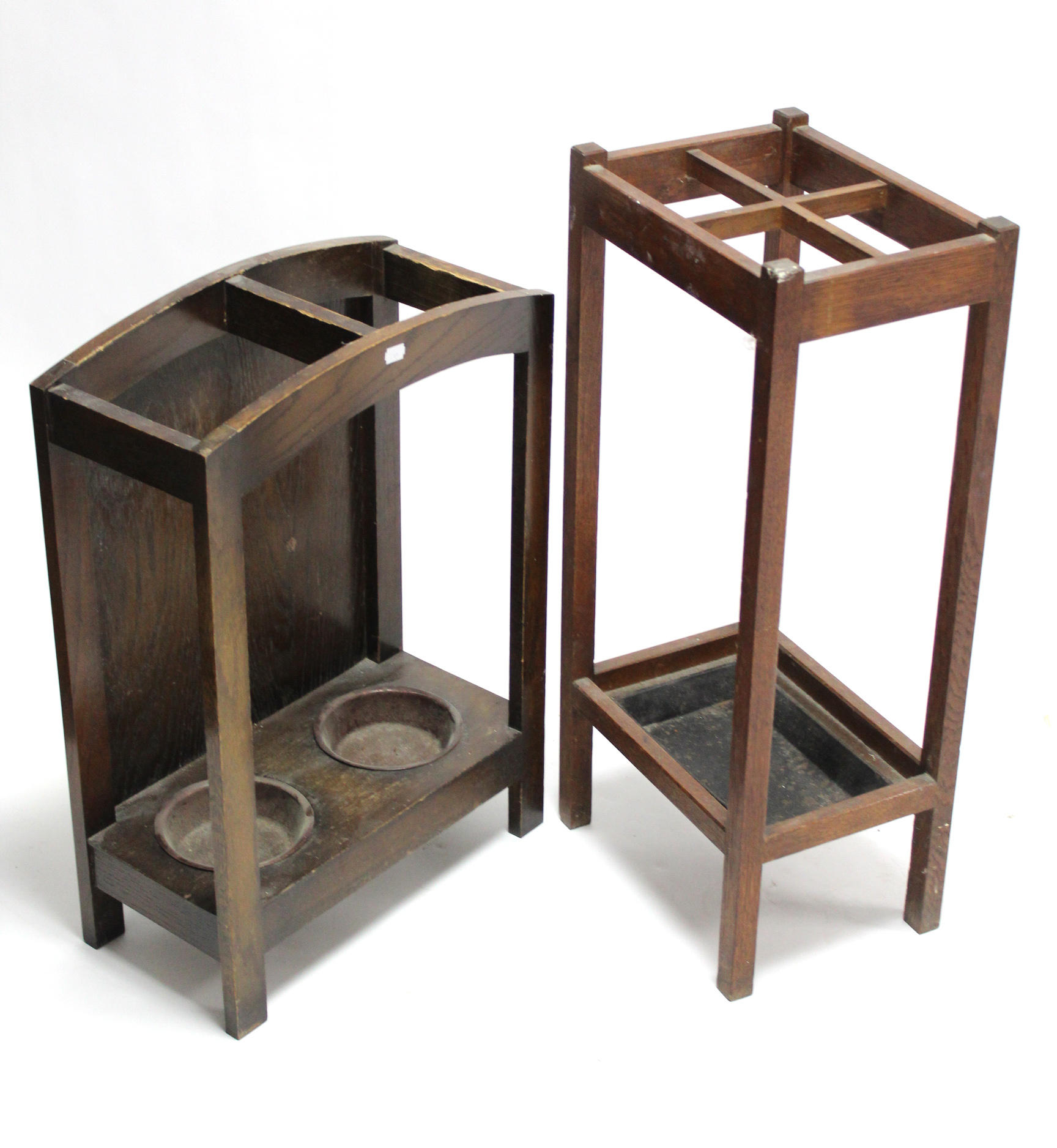 A 1930’s oak four-division umbrella stand, 29” high; & an oak two-division ditto, 25” high.