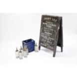 Six Schweppes glass soda syphon bottles; a Schweppes blue plastic six-division crate; & three