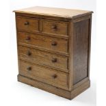 A small oak chest fitted two short & three long drawers with turned knob handles, & on plinth