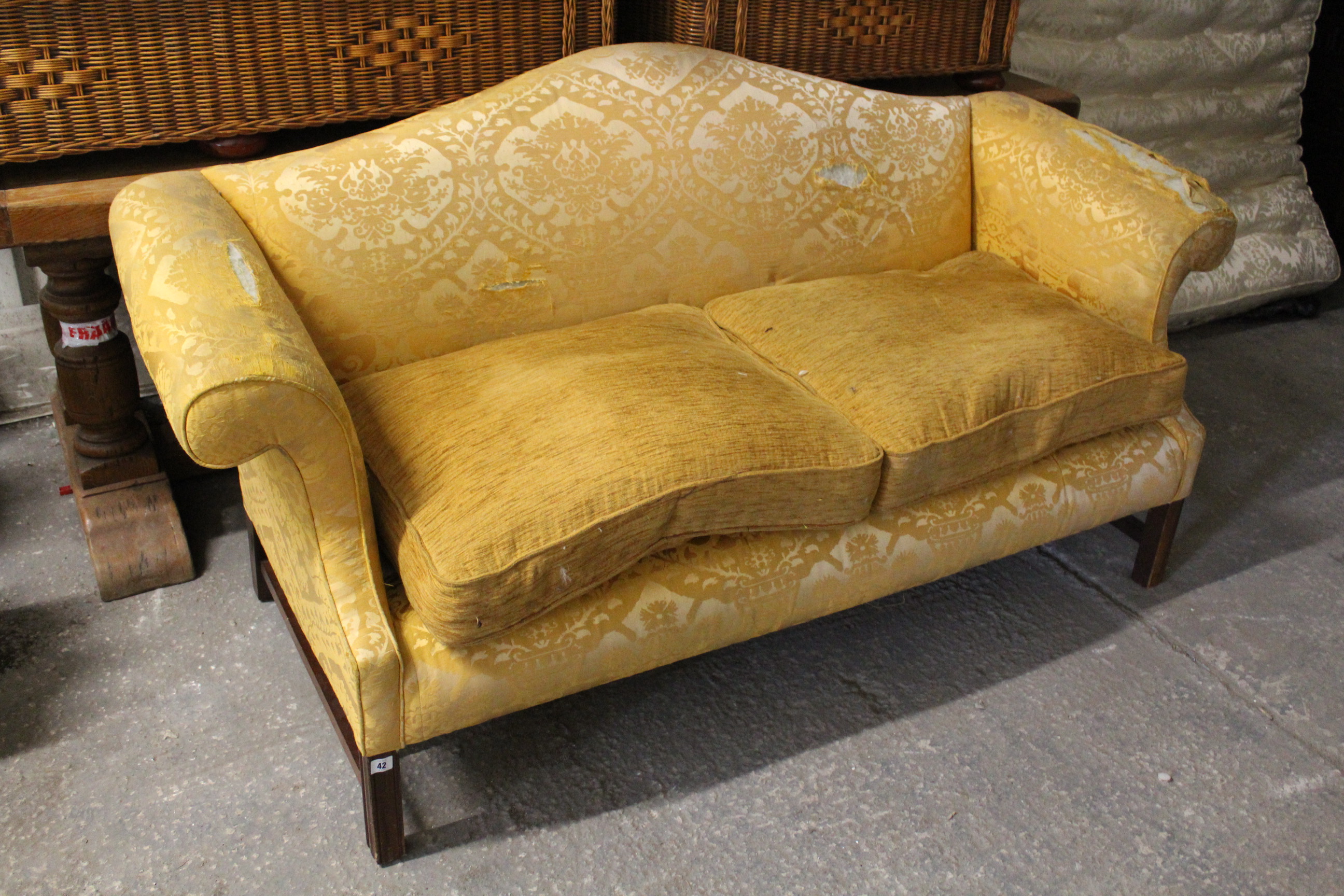 A Georgian-style three-seater settee (requires reupholstering) with shaped back, scroll-arms &