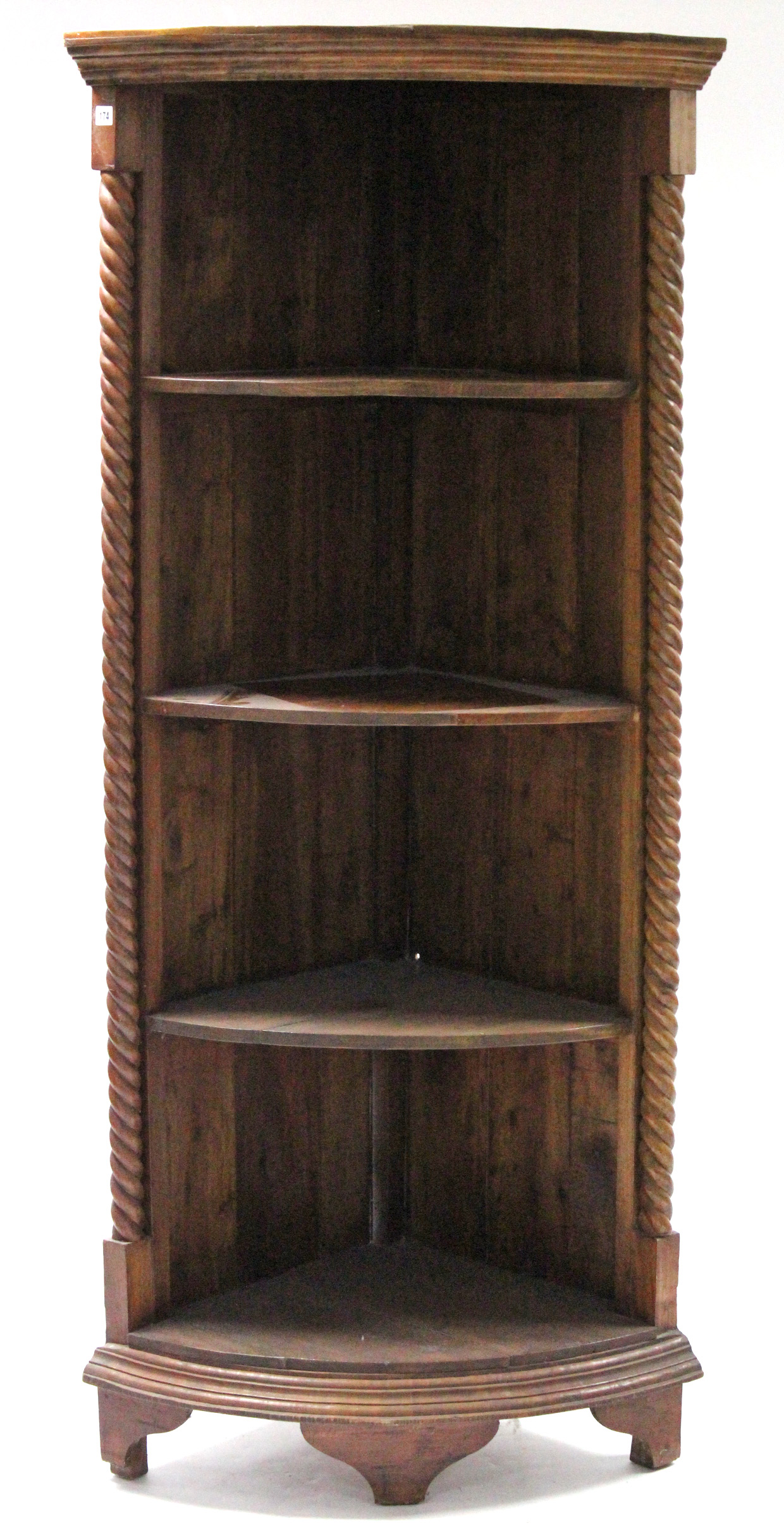 A teak tall standing four-tier open corner bookcase with spiral-twist pilasters, & on bracket