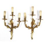 A pair of gilt ormolu rococo-style triple branch wall lights, 12” wide x 19½” high.