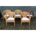 A set of four wicker conservatory chairs; & another wicker conservatory chair.