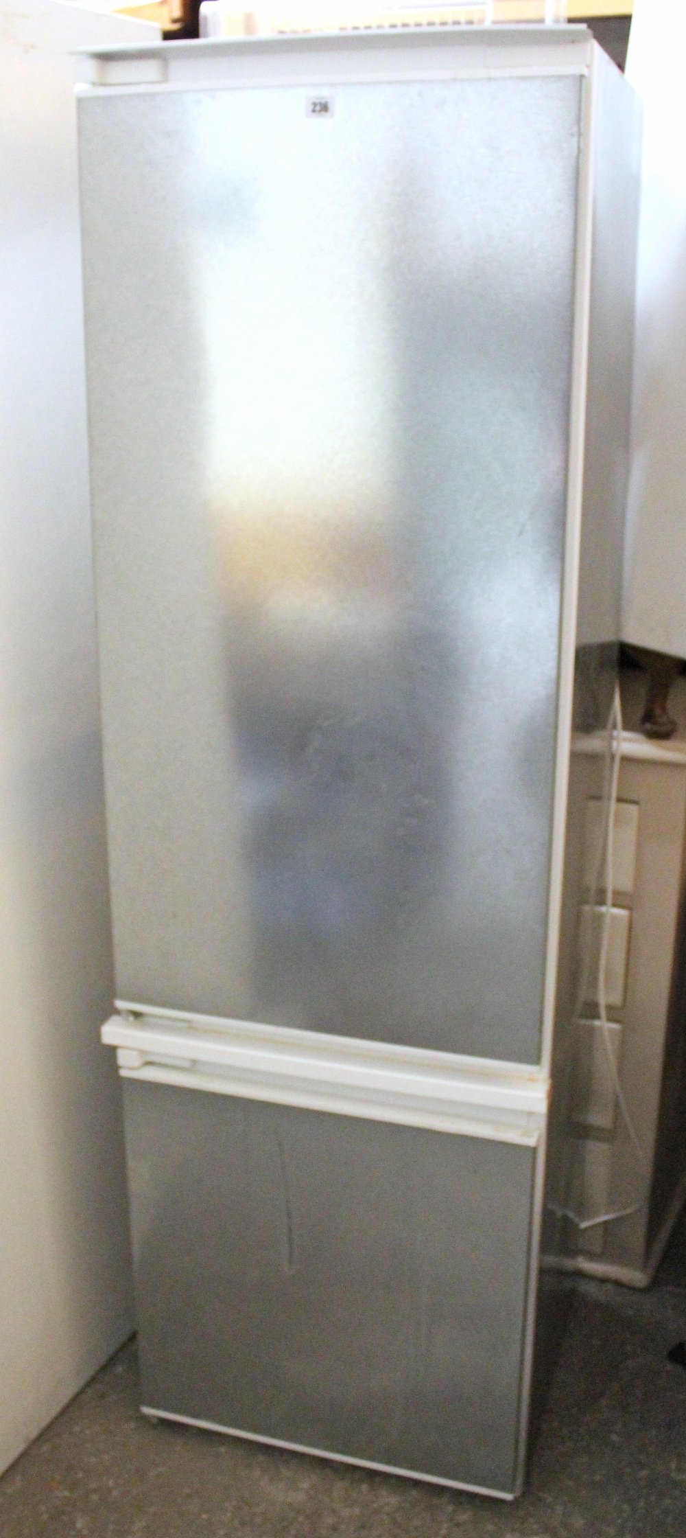 A Bosch integrated fridge-freezer in stainless steel case, 21” wide x 70” high, w.o.