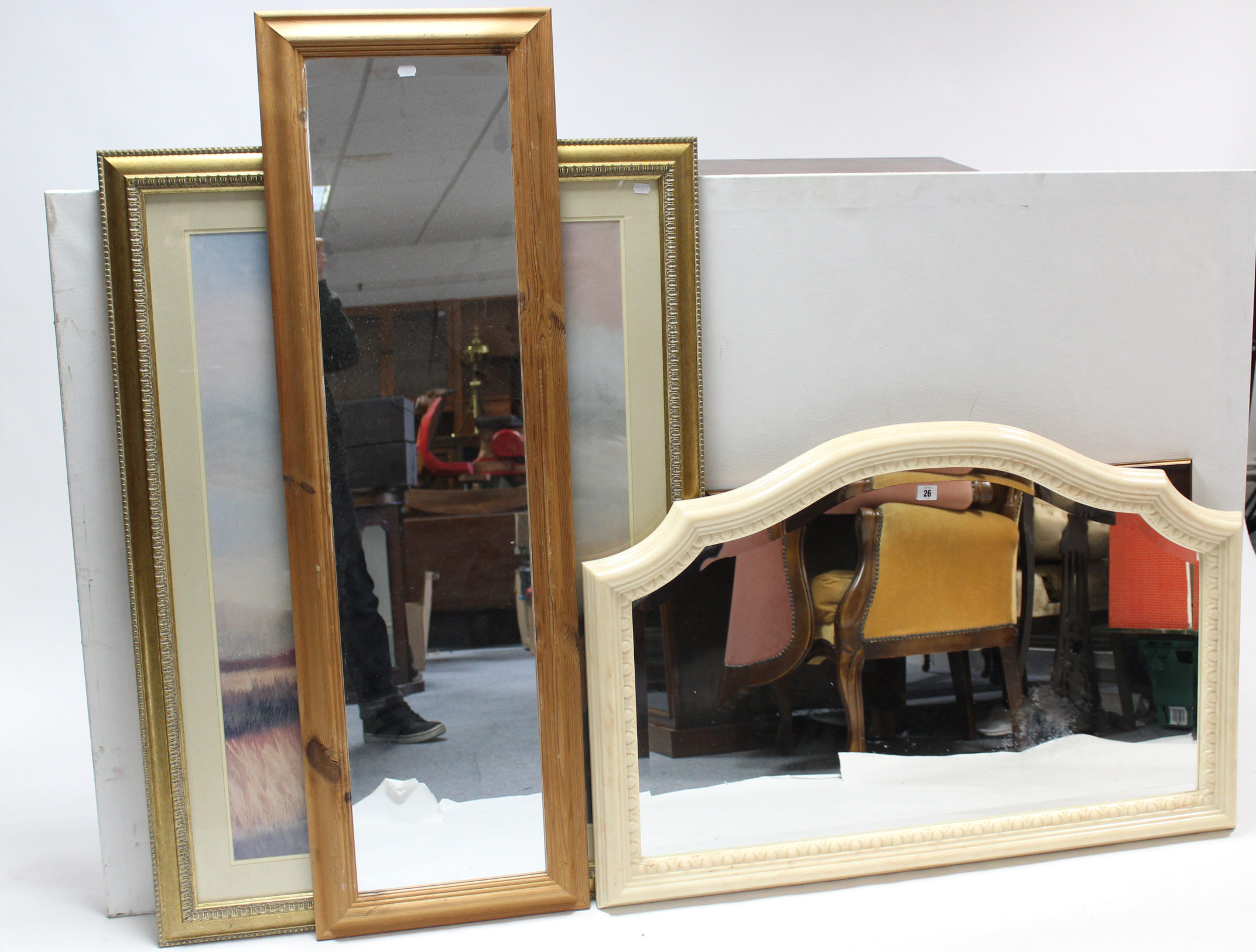 An overmantel mirror in white composition frame, with rounded top, & inset bevelled plate, 28” x