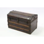 An early 20th century fibre-covered ribbed domed-top travelling trunk fitted with a removable tray