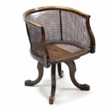 A late 19th/early 20th century beech swivel office chair with woven cane seat & back (cane w.a.