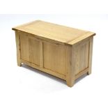 A light oak blanket box with hinged lift-lid & panelled sides, 36” wide x 20¾” high.