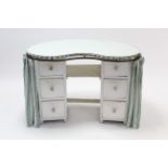 A white painted wooden kidney-shaped kneehole dressing table fitted six drawers, & with drapes,