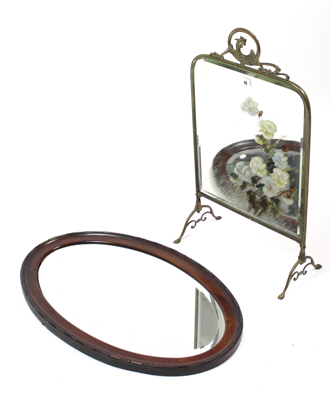 A Victorian brass-frame fire screen inset floral painted bevelled mirror plate, 17½” wide; & an