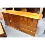 A good quality mahogany-finish sideboard, the right hand side fitted with an arrangement of six