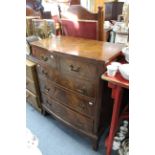 A reproduction mahogany small bow-front chest, fitted two short & three long graduated drawers, & on
