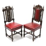 Two late 19th/early 20th century carved oak side chairs, each with sprung seat upholstered crimson