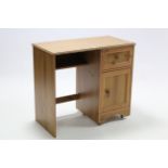 A pine knee-hole dressing table fitted frieze drawer above cupboard to the right-hand side, 33¾”