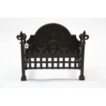 A cast-iron fire grate with raised urn design to the rounded back, 24” wide x 18” high.