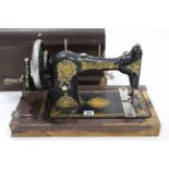 A vintage Jones hand-sewing machine with case.