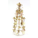 A Harrods gilt-metal candle standard adorned with numerous cherub figures, 32” high, boxed.