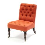 A Victorian nursing chair upholstered button crimson material, & on short turned legs with ceramic