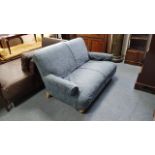 A two-seater settee upholstered blue material, & on short turned legs, 58” wide.