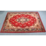 A Kashmir wool carpet of crimson & ivory round with floral design to centre within a wide border, 9’