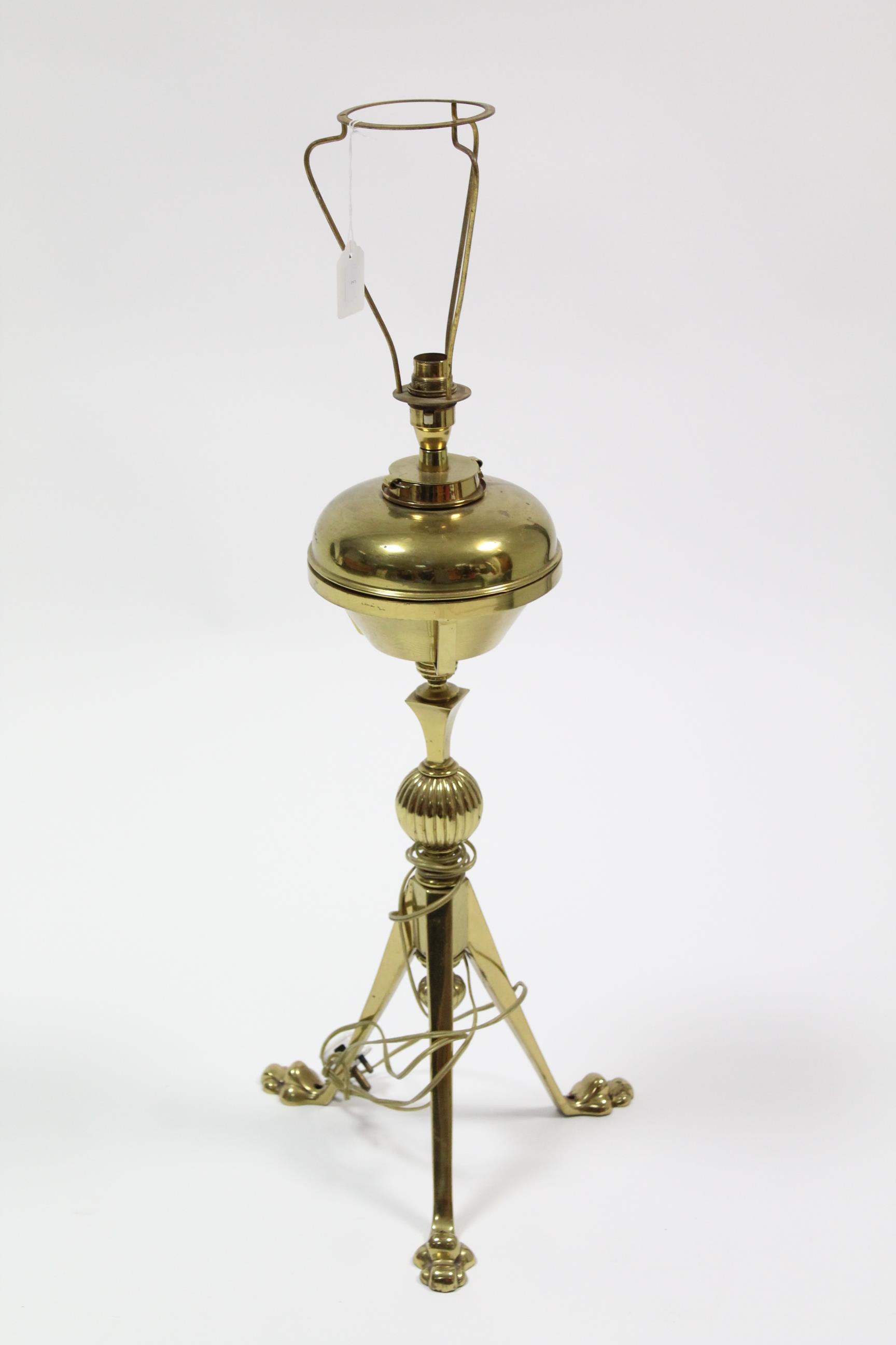 A Victorian brass oil table lamp (converted to electricity) on triform base, 30” high.