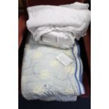 Three various quilts; & various items of household linen & clothing.