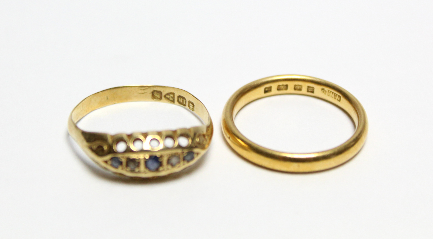 A 22ct gold wedding band; & an 18ct gold ring inset five precious stones - Image 4 of 4