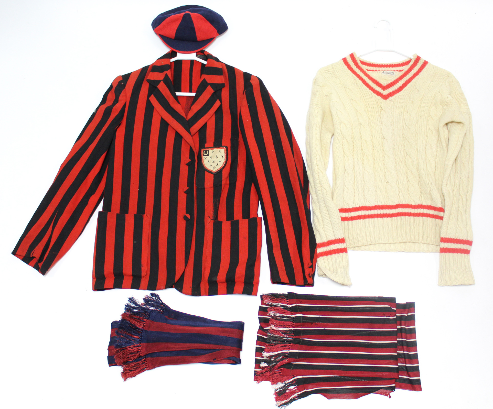 A school blazer, jumper & two scarves.