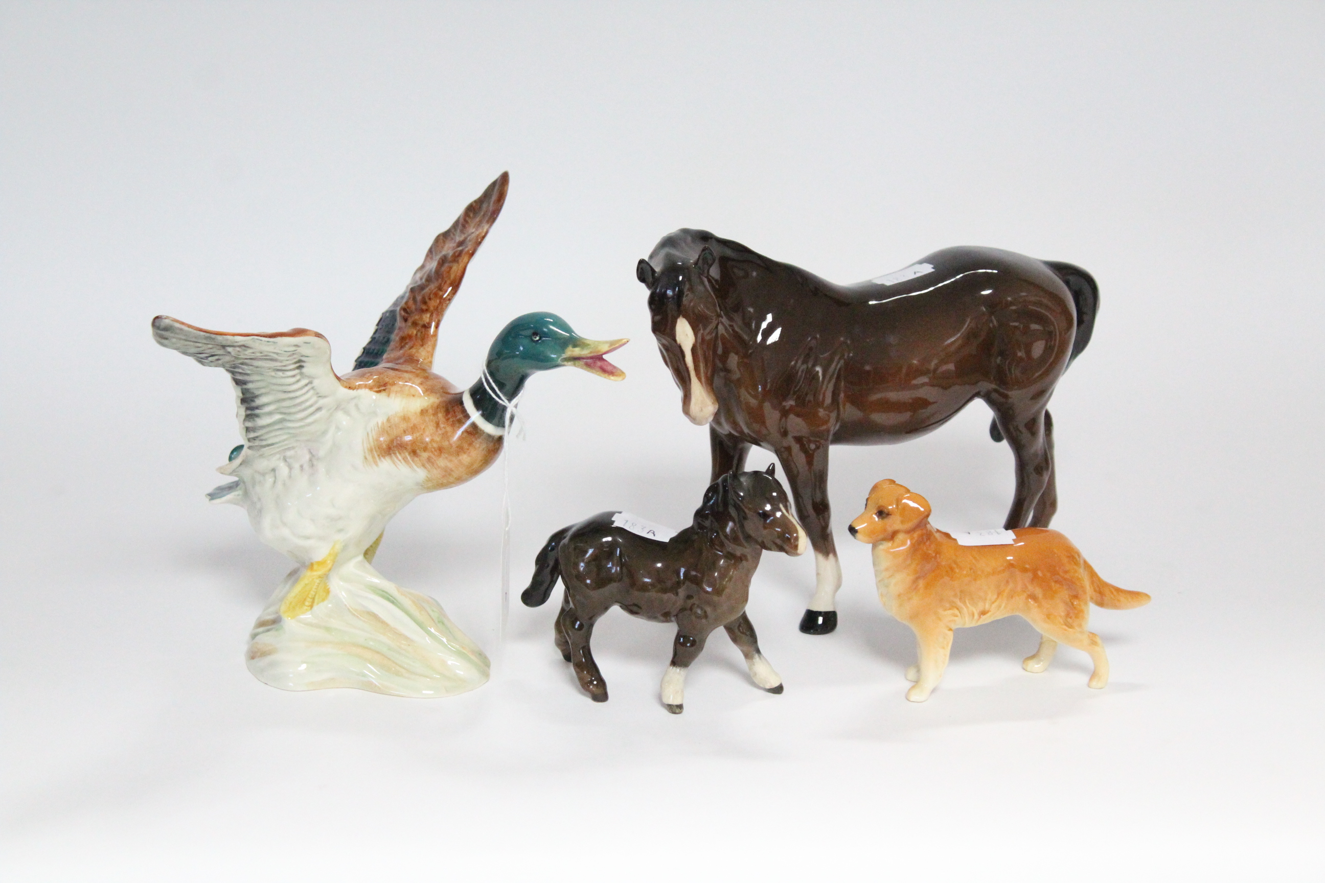 A Beswick model of a Duck (No. 749); a Beswick model dog; & two Beswick model horses.