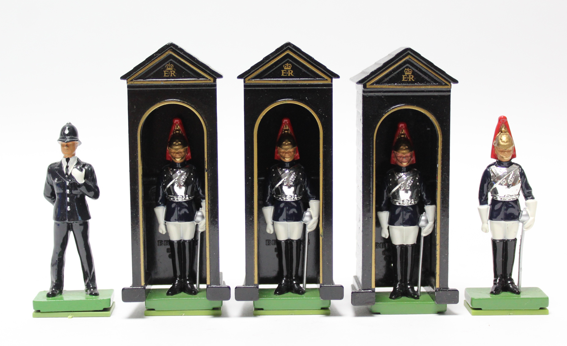 Three Britains painted metal Sentry boxes, four painted-metal Sentry Guards, & a painted metal
