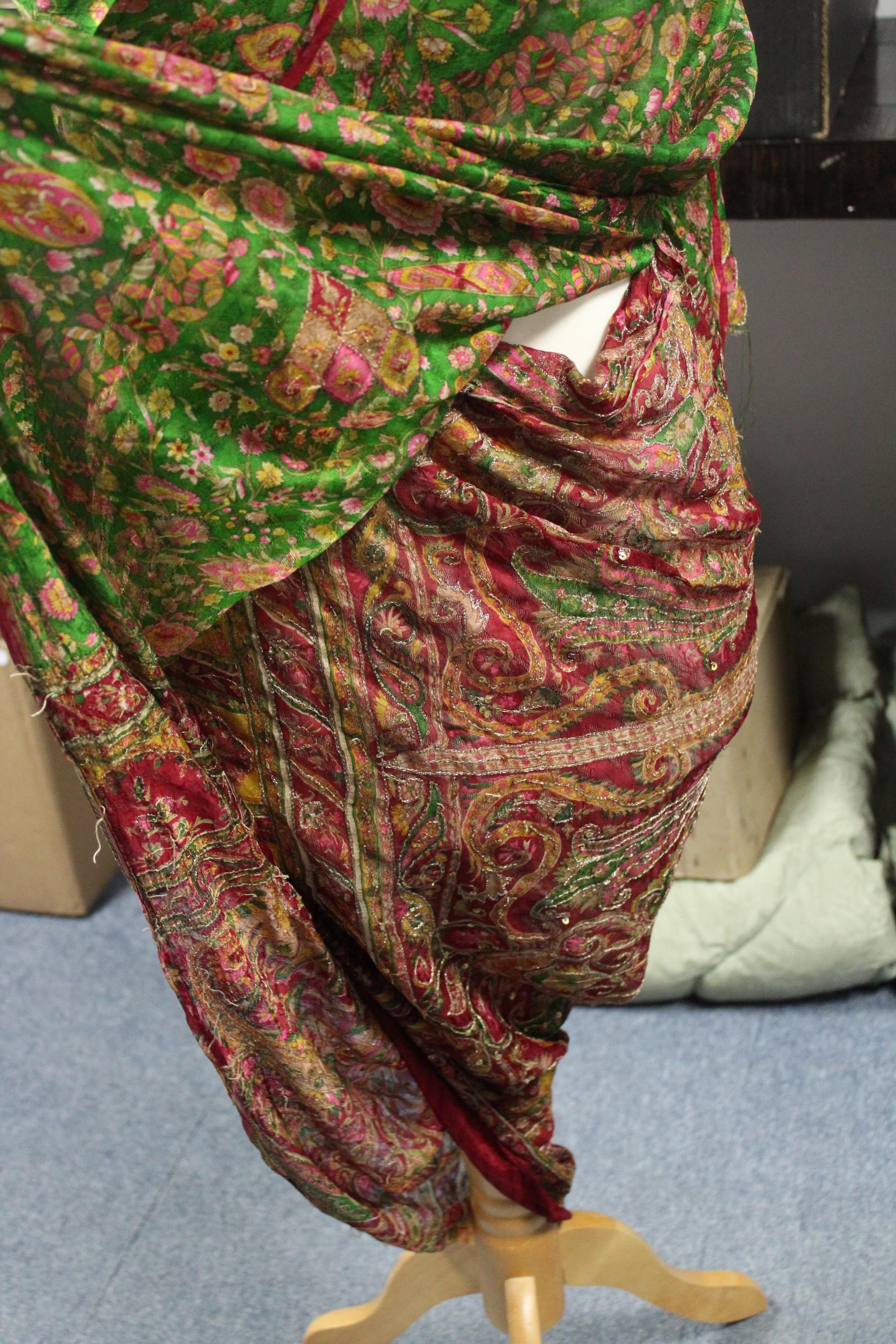 An Indian sari of green & crimson ground with all-over floral & scroll design to one end & with - Image 2 of 3