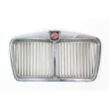 A chrome grille from a vintage “MG” motor car.