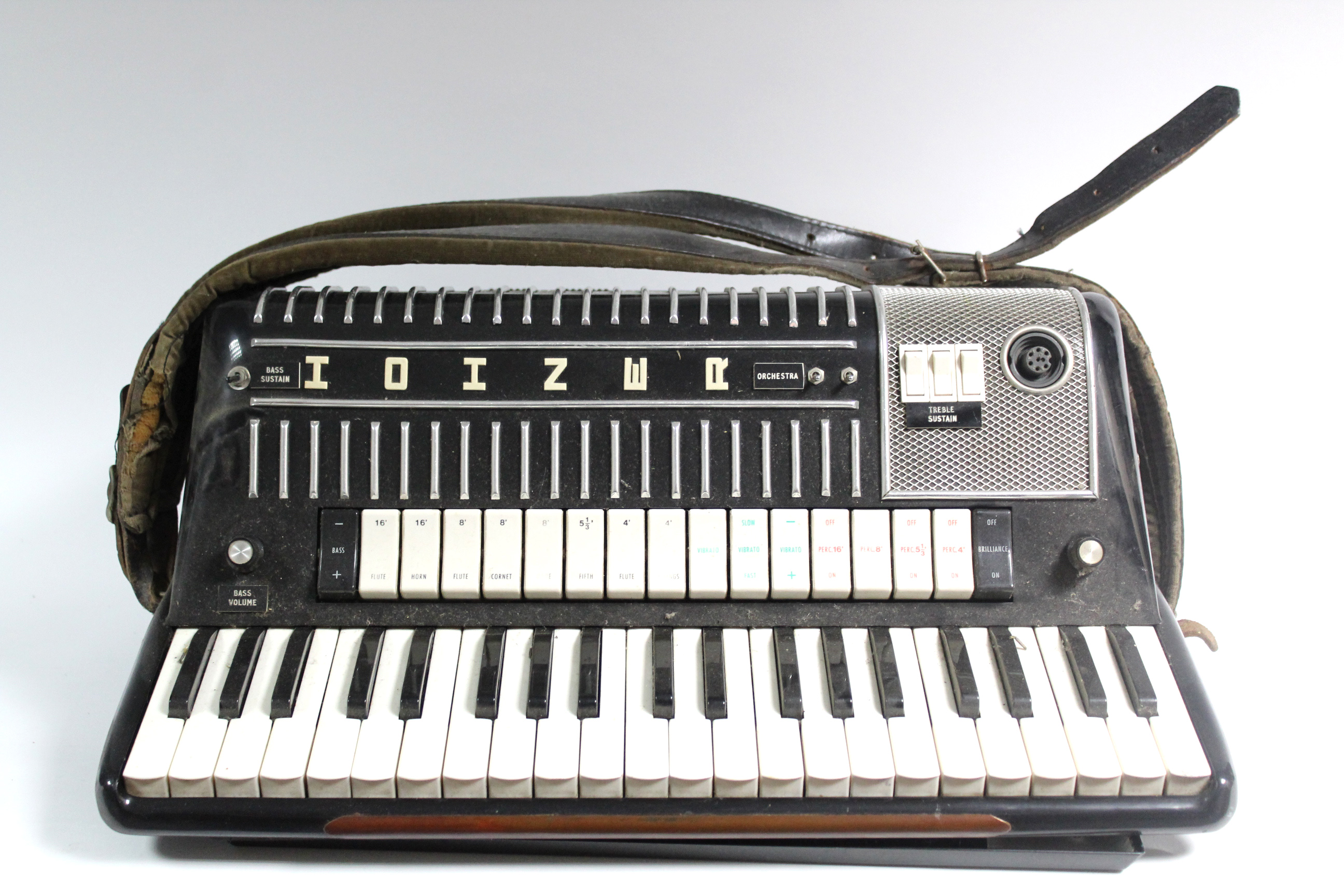 A Hohner electrically operated piano accordion, with case.