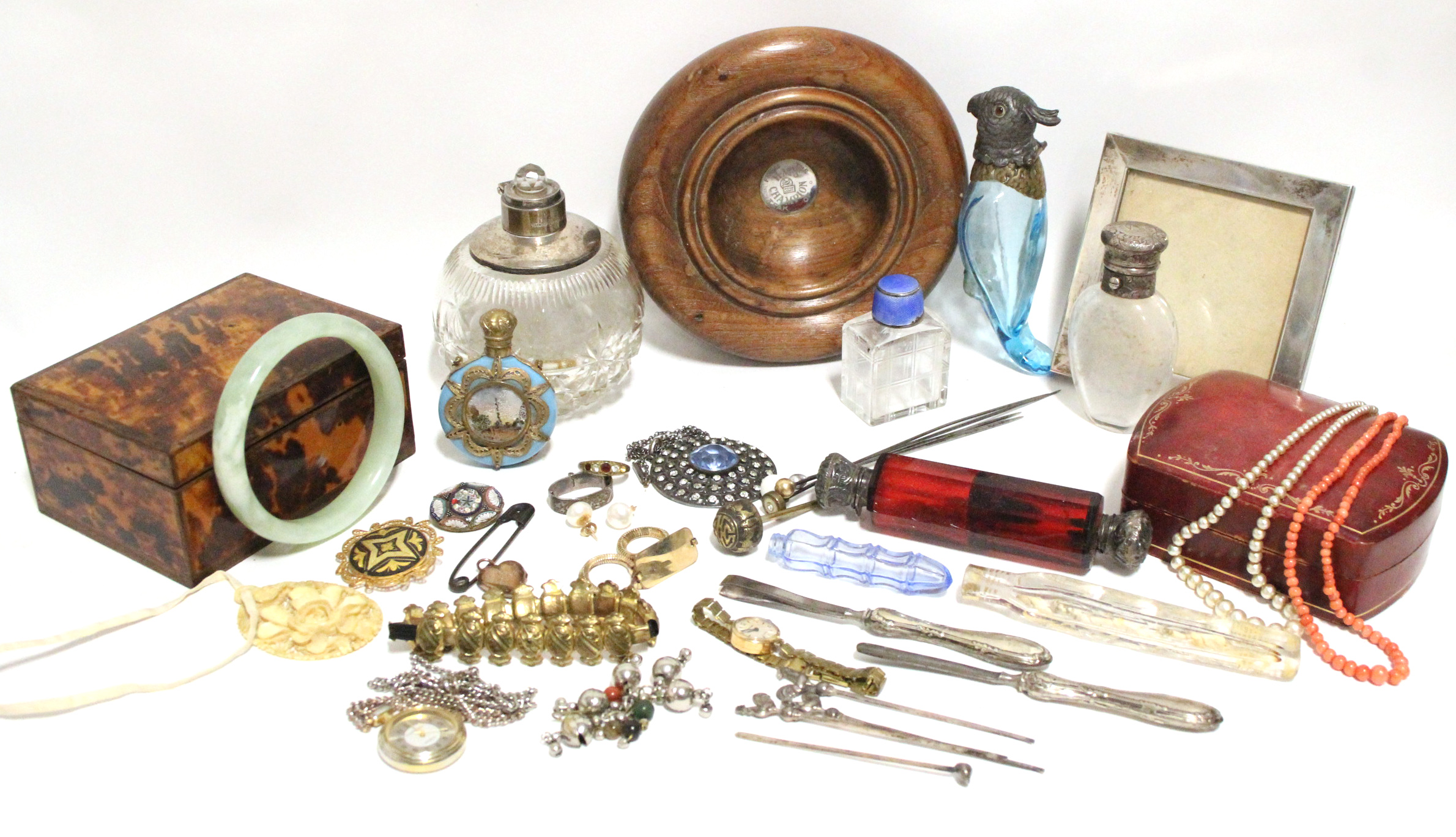 Various scent bottles; a tortoiseshell veneered box; a small square silver photograph frame, etc.