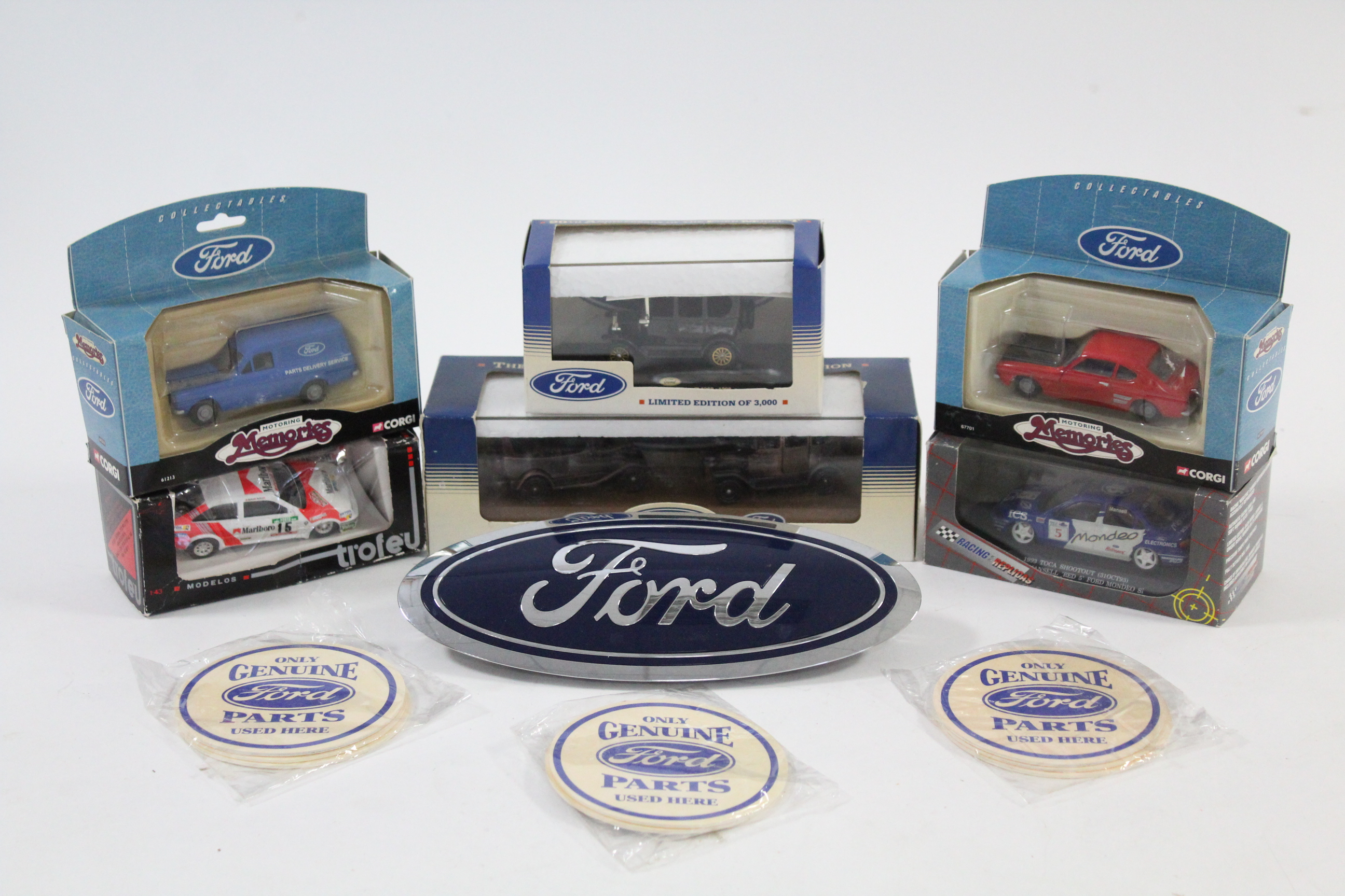 Four various scale model Ford vehicles; together with two other scale models, each in window box;