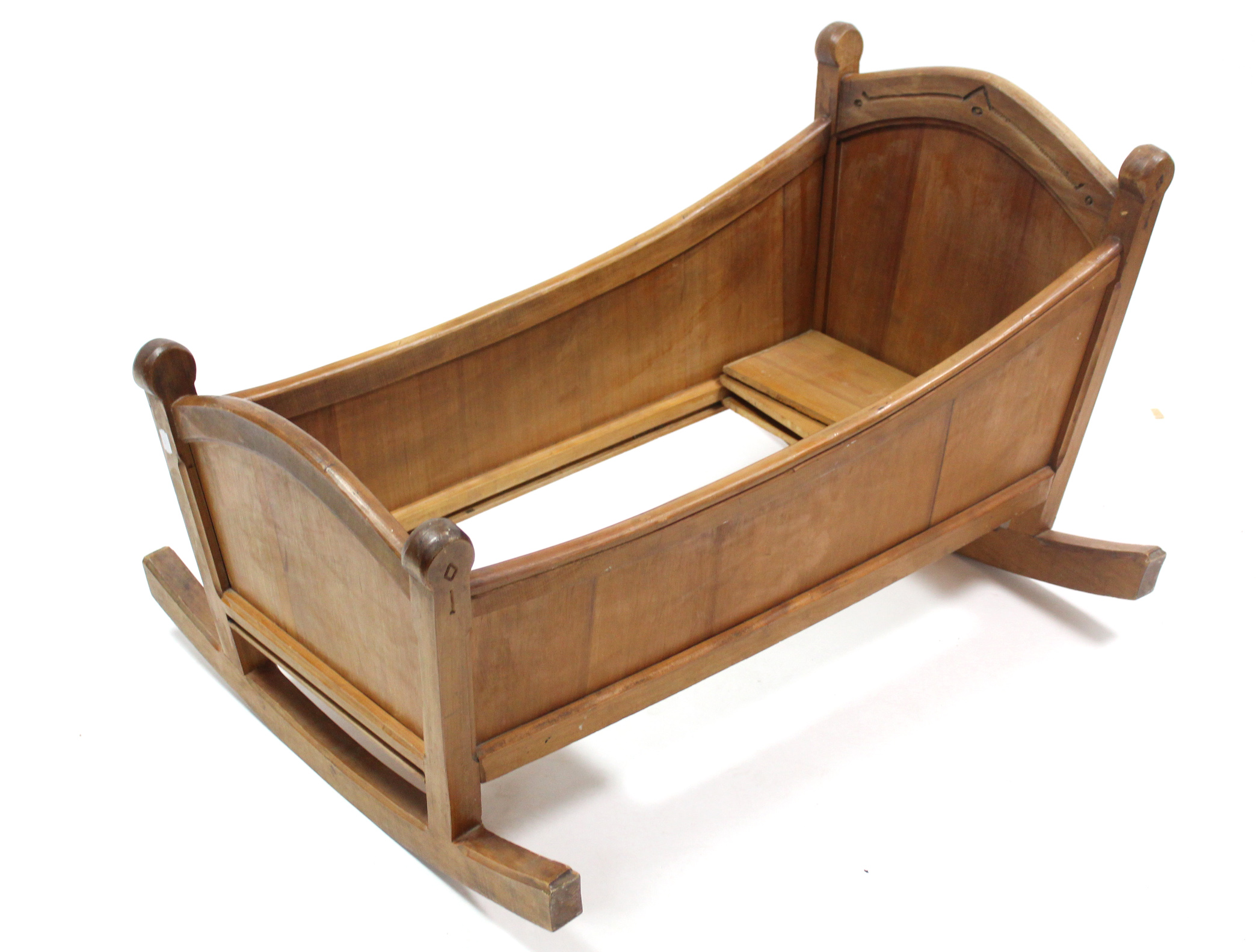 A mid-20th century carved pine cradle, 36” long x 20½” high.