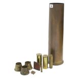 A WWII brass shell case (1943), 18” high; six other shell cases; & a cap badge.