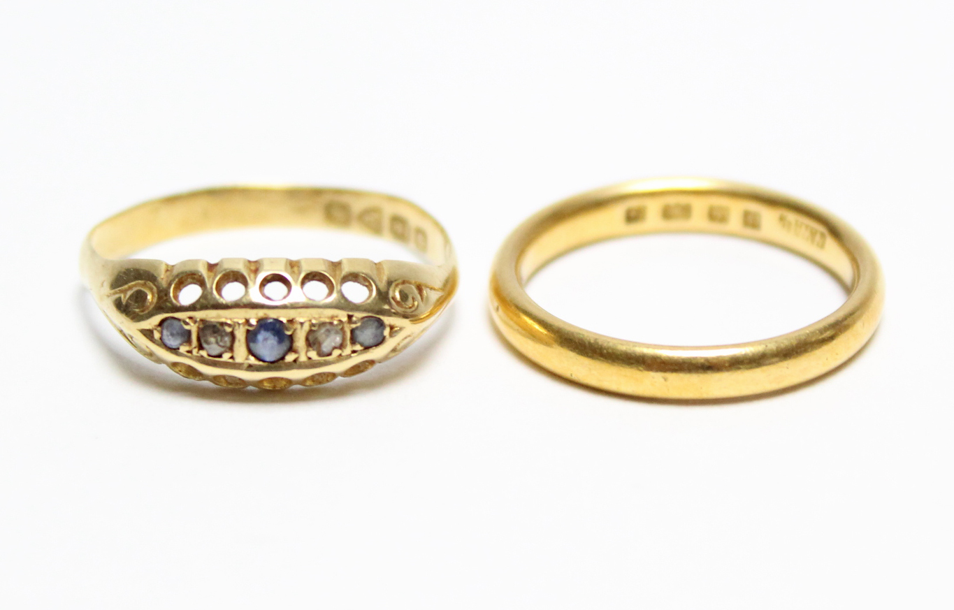 A 22ct gold wedding band; & an 18ct gold ring inset five precious stones