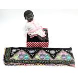 A Pedigree black celluloid baby doll, 21” high, dressed; & five embroidered velour panels.