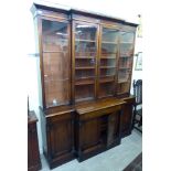 An early Victorian mahogany breakfront library bookcase, the level cornice over four in-line,