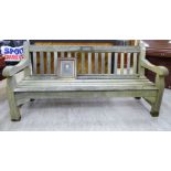 'The Wren Memorial Seat' a teak framed garden bench seat of slatted construction with open arms