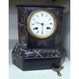 A late Victorian black slate and marble cased mantel clock with straight,