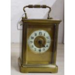 An early/mid 20thC lacquered brass cased carriage timepiece with bevelled glass panels and a