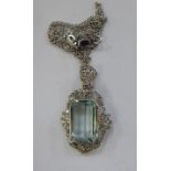 An 18ct white gold pendant necklace, set with a central baguette cut aquamarine,