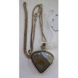 A white metal pendant, set with triangular shaped agate,