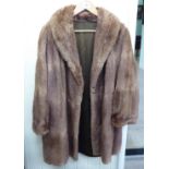A lady's light brown, three-quarter length fur jacket with wide cuffs and collar approx.