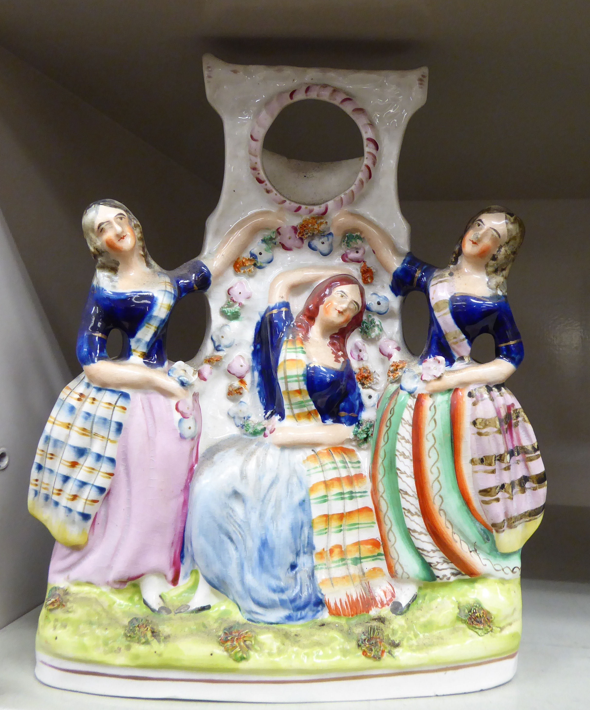 A mid 19thC Staffordshire pottery flatback watchstand, featuring Scots Lassies,