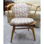 An Ercol light elm and beech framed side chair with a horseshoe shaped back and solid seat,