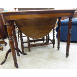A late Victorian mahogany side table, the narrow top raised on straight,